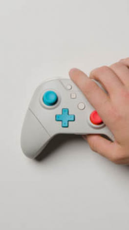 Estudio-De-Video-Vertical-Mano-Alcanzando-Para-Recoger-El-Controlador-De-Videojuegos-1